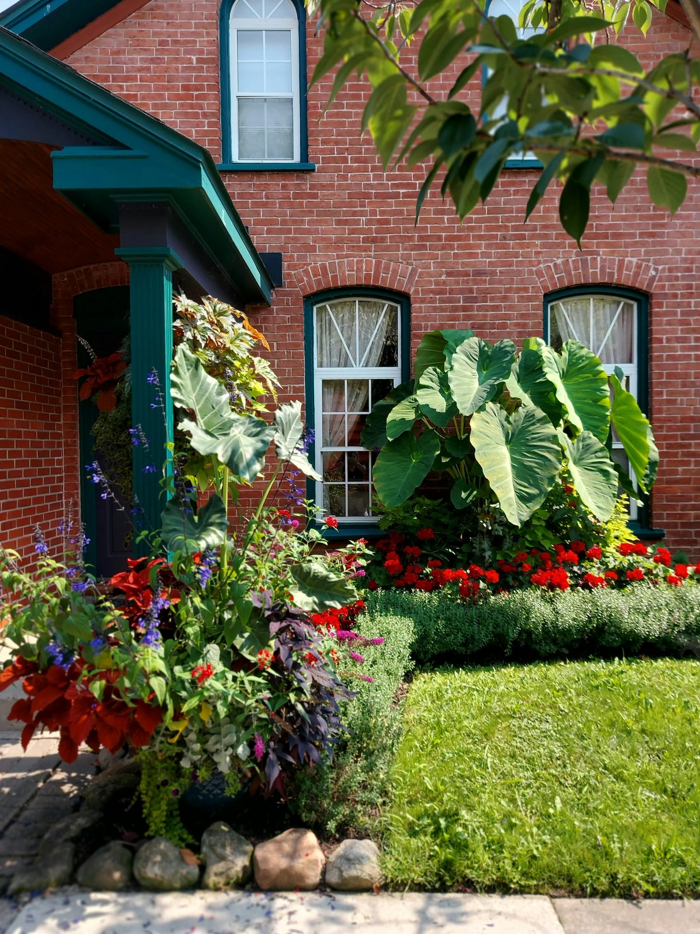 Brick house porch with lush plantings